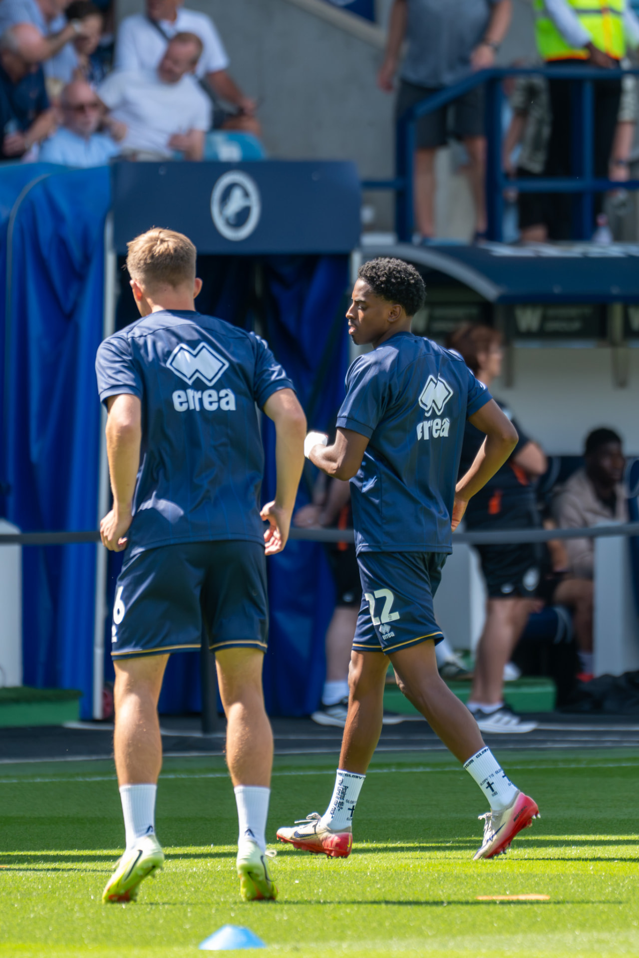Two players talking on the touchline before the match