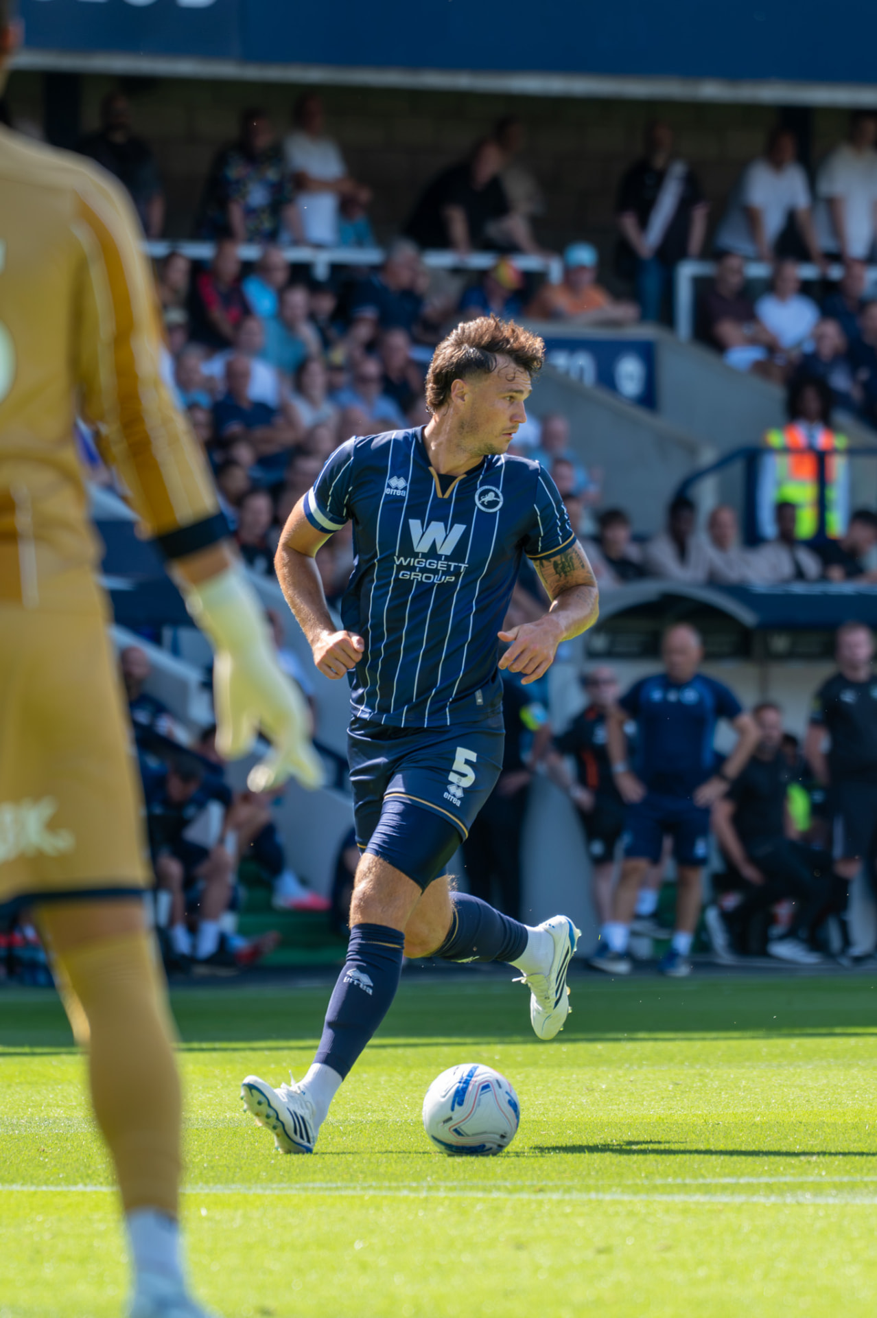 Millwall number 5 carrying the ball forward
