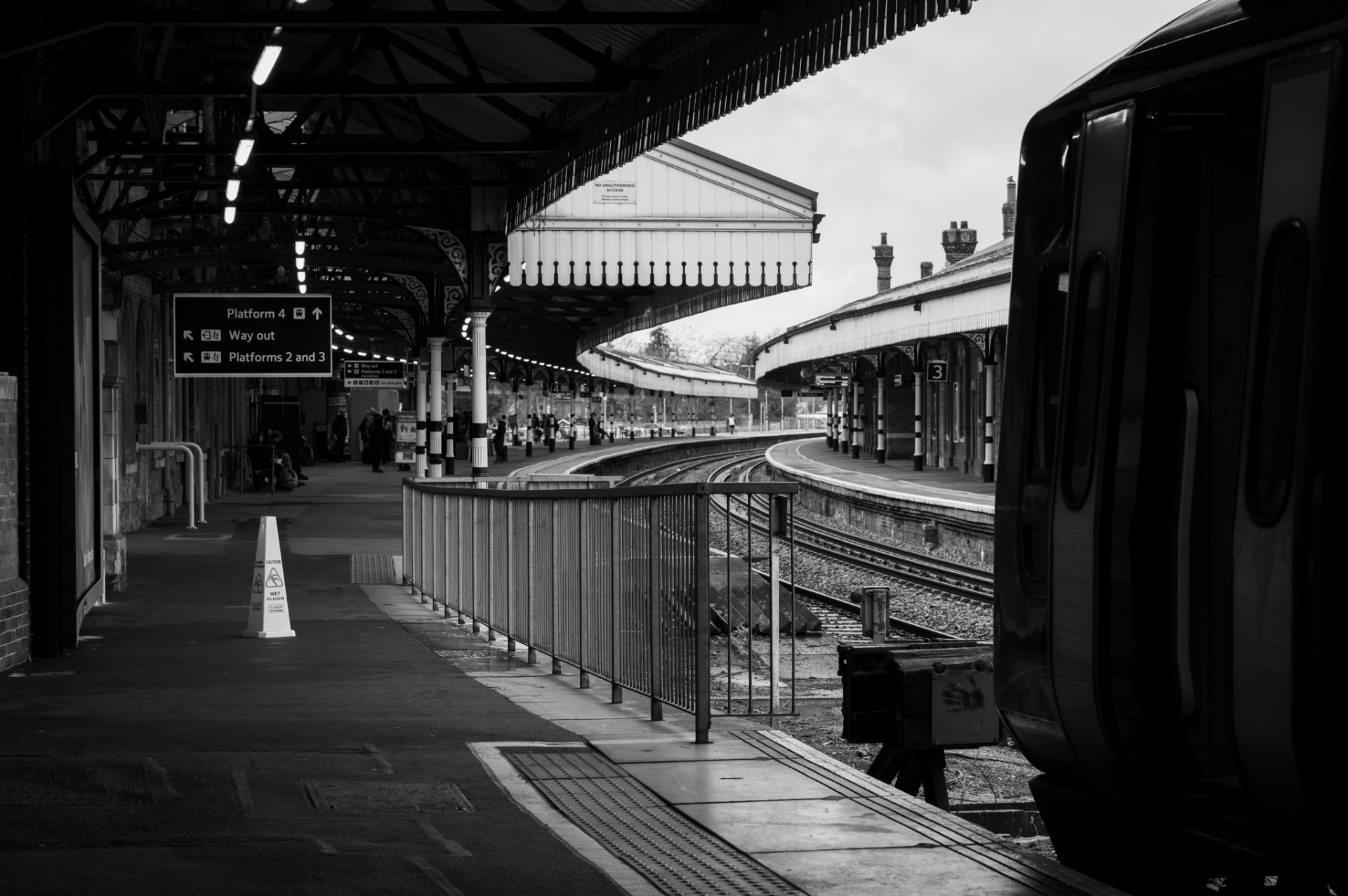 Curved Victorian railway platform with signage