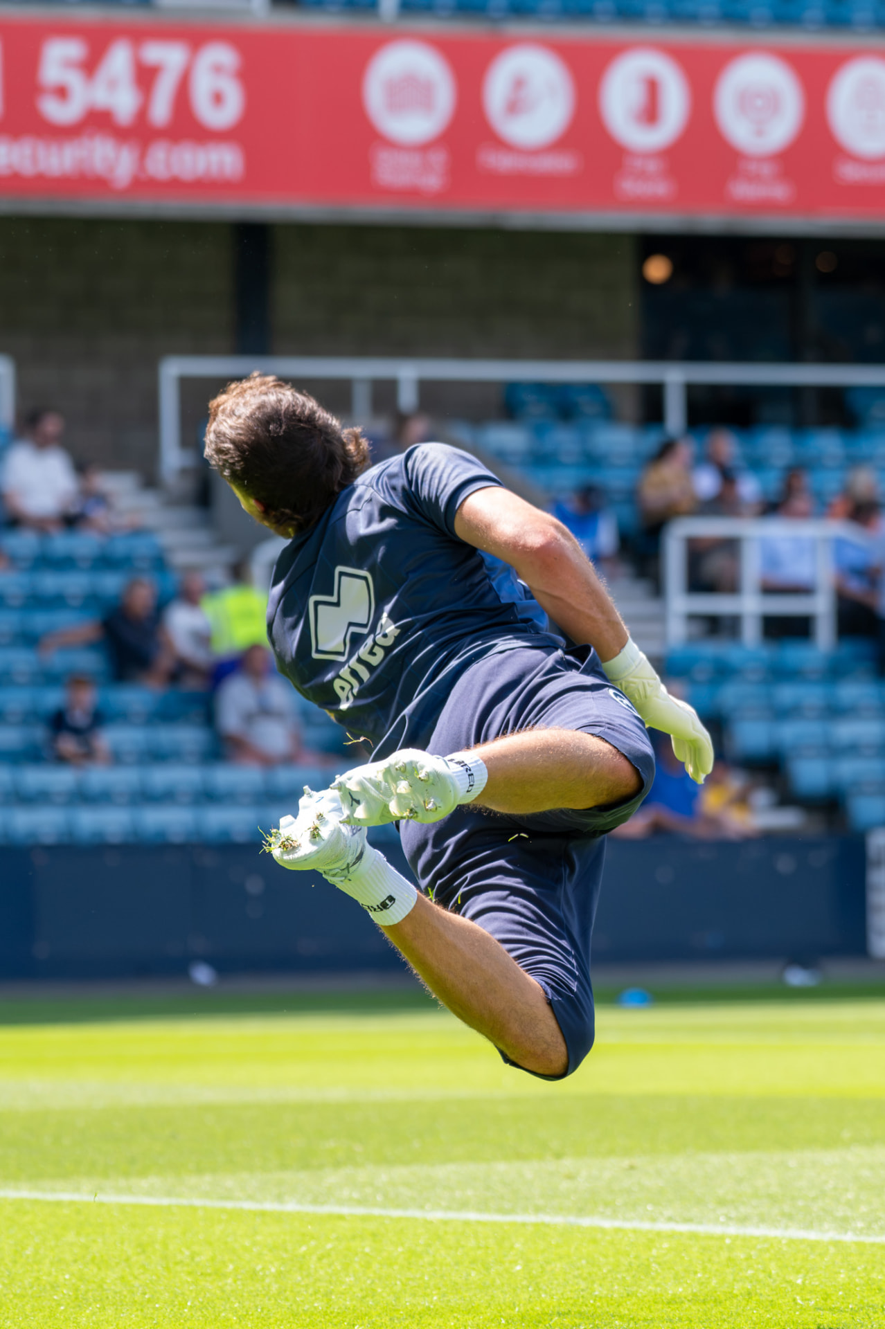 Goalkeeper mid-air diving across goal