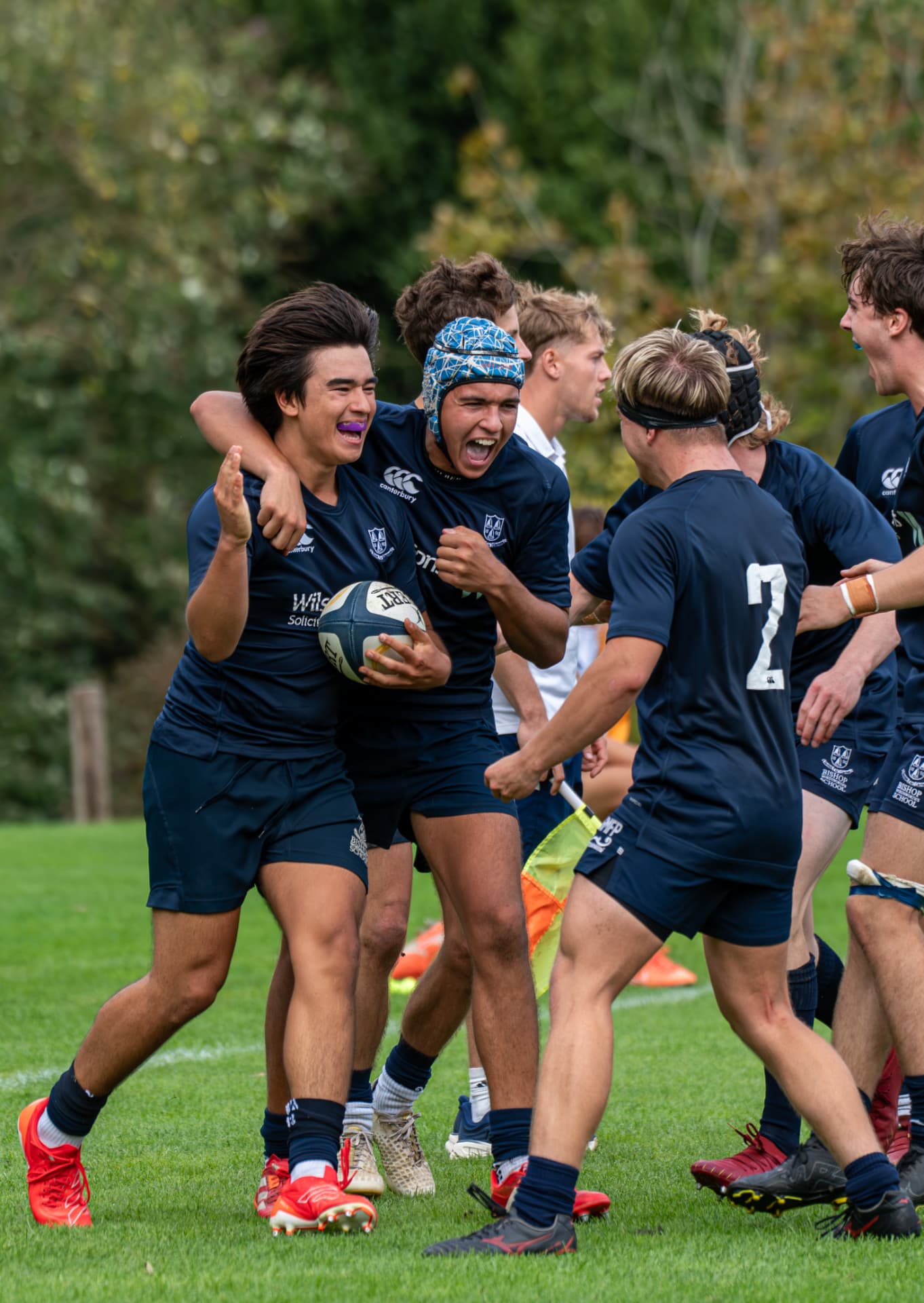 Rugby players celebrating a try together on the pitch