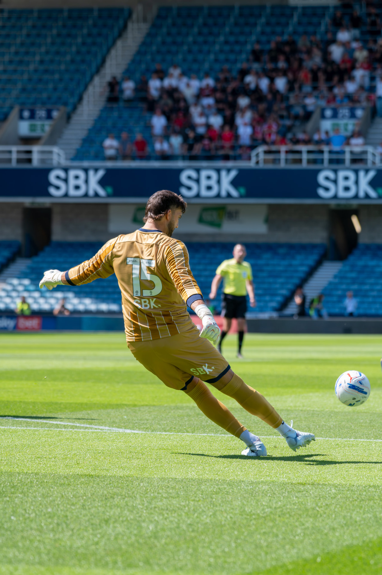 Goalkeeper striking a goal kick downfield