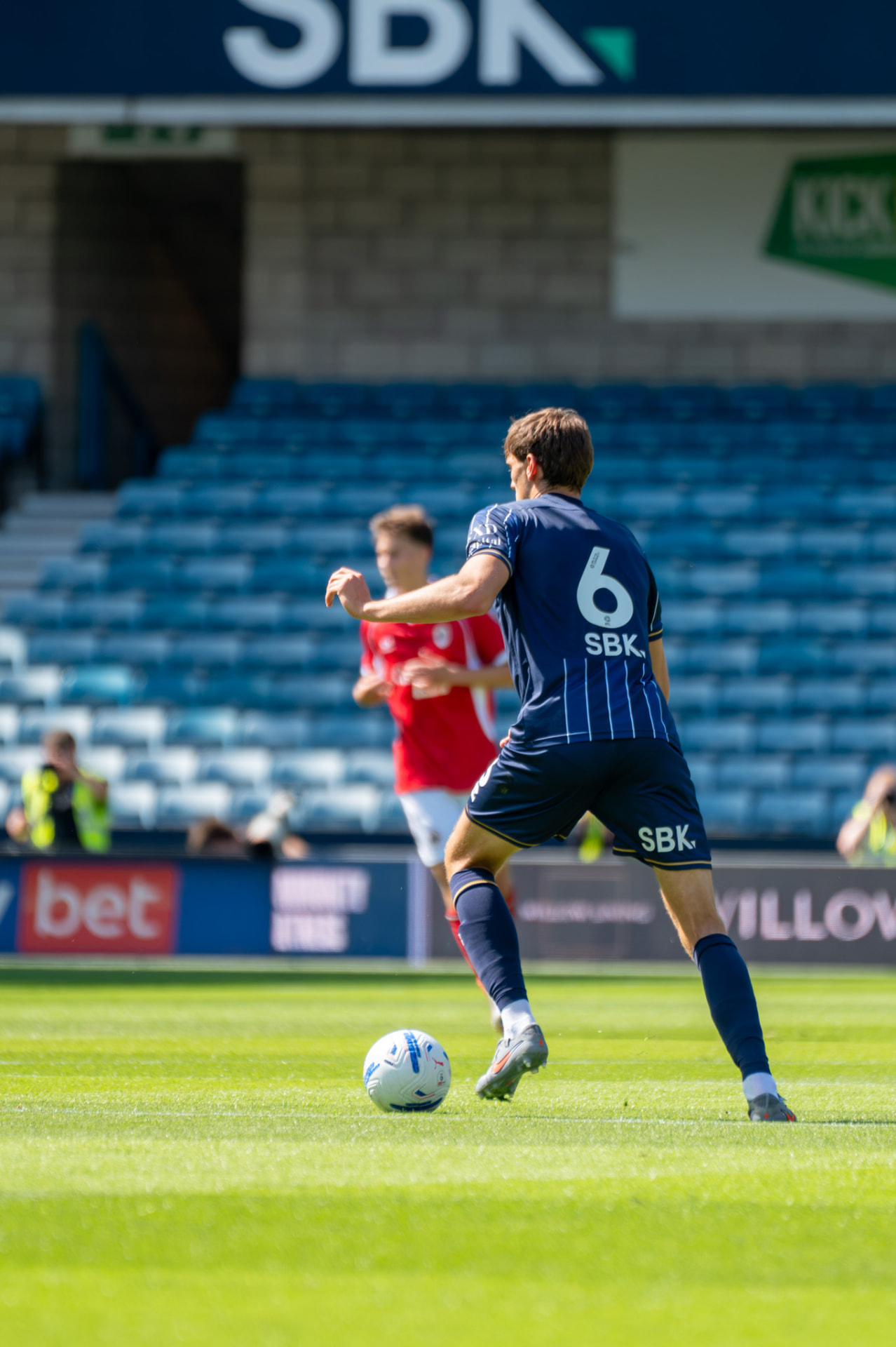 Millwall number 6 stepping onto the ball