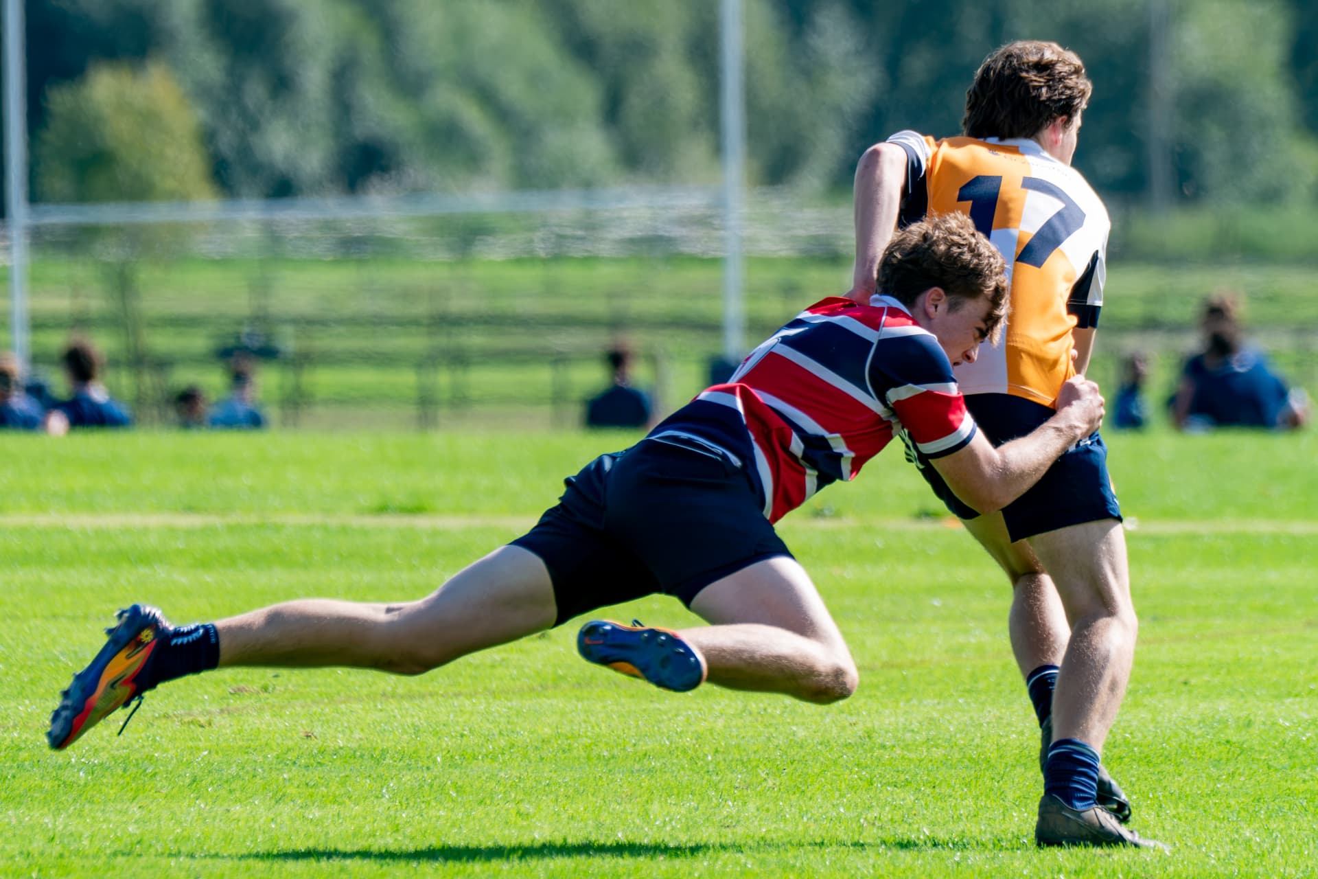 Rugby player making a diving tackle