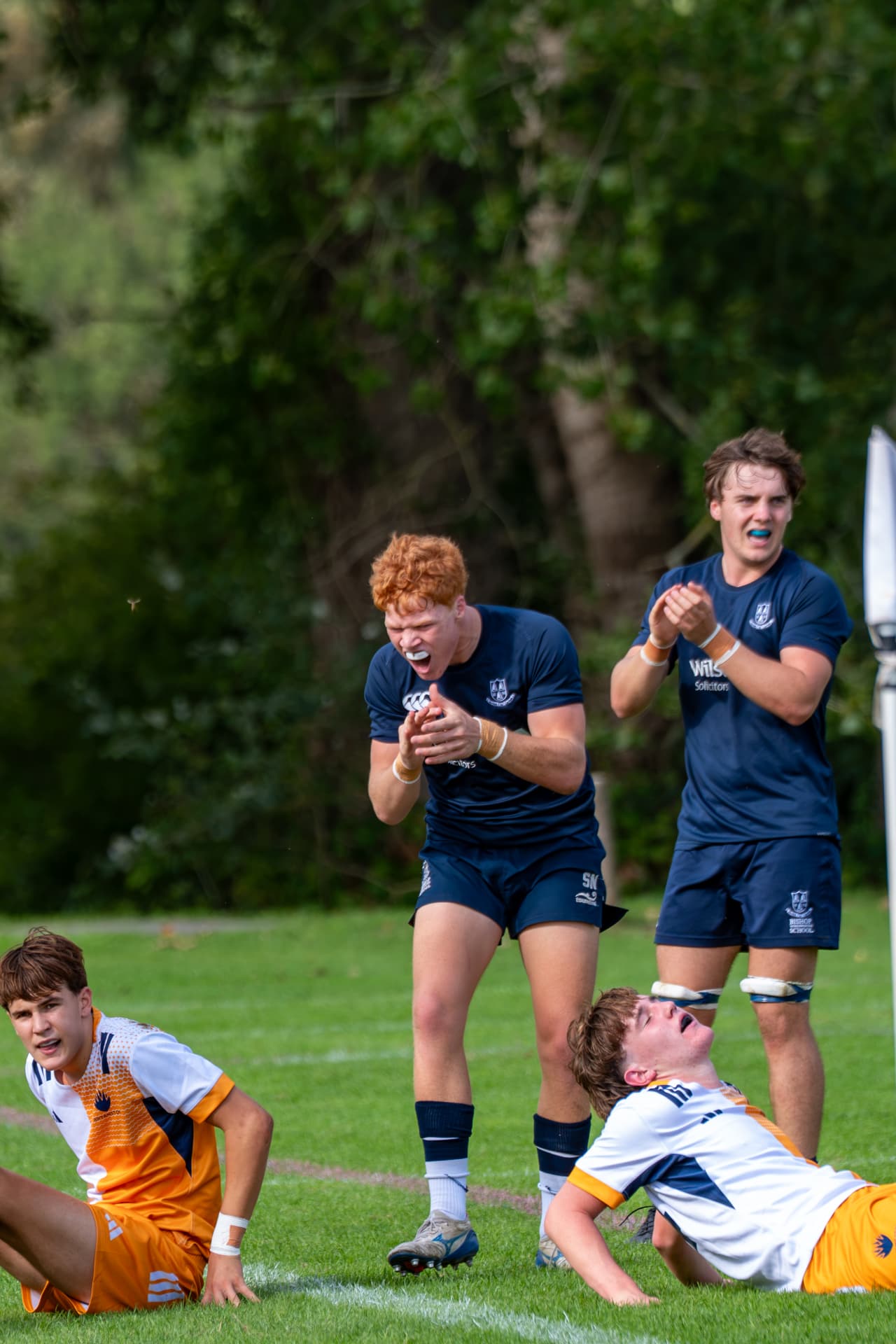 Rugby players reacting from the touchline