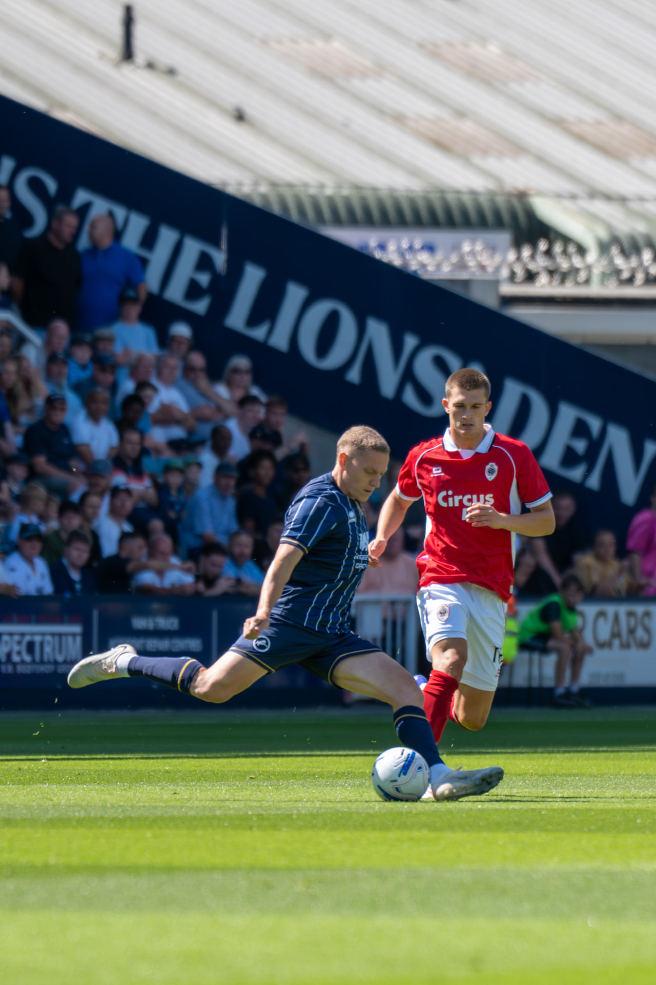 Player stretching to deliver a cross under pressure