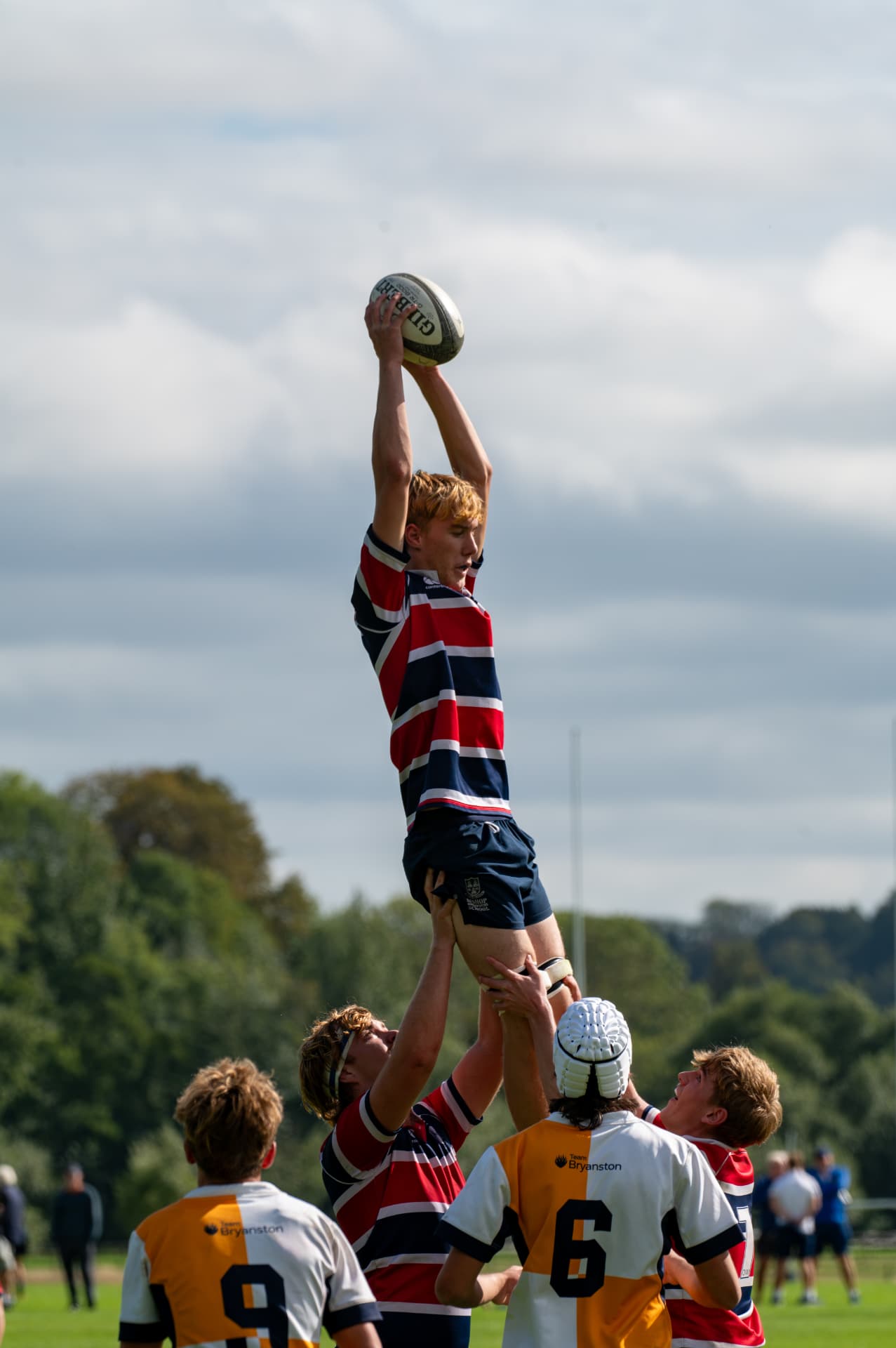 Rugby player catching the ball high in a lineout