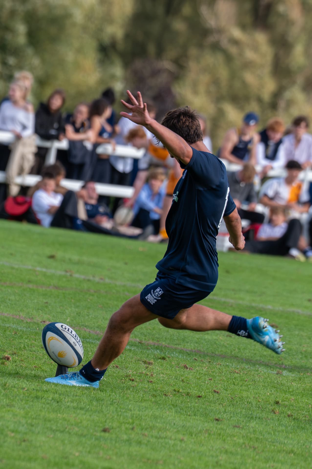 Rugby player striking a placed kick