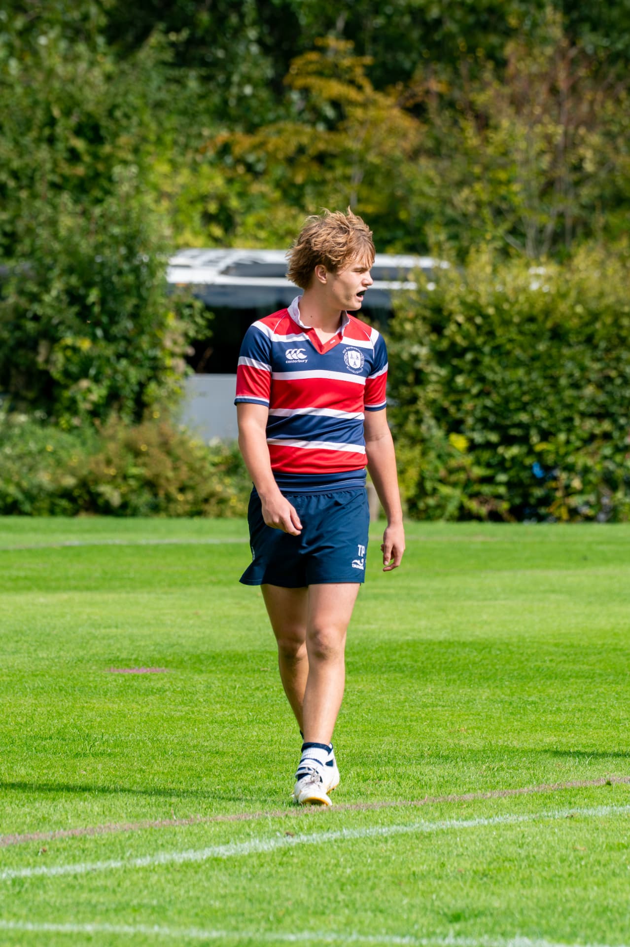 Rugby player walking across the pitch