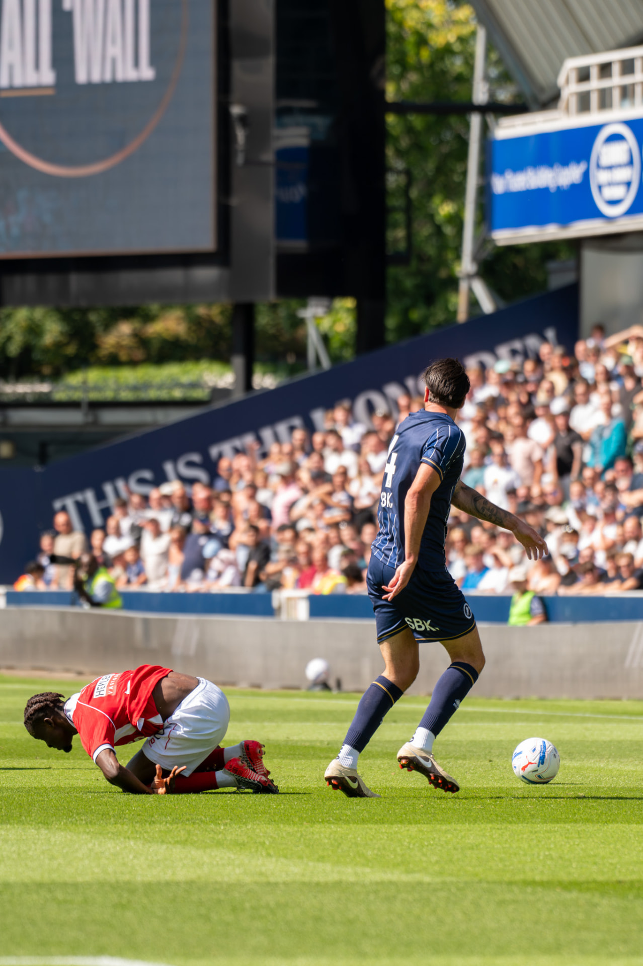 Player coming away with the ball after a challenge