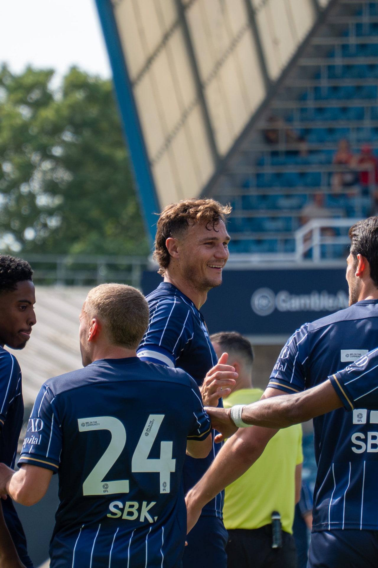 Millwall players celebrating together after a goal