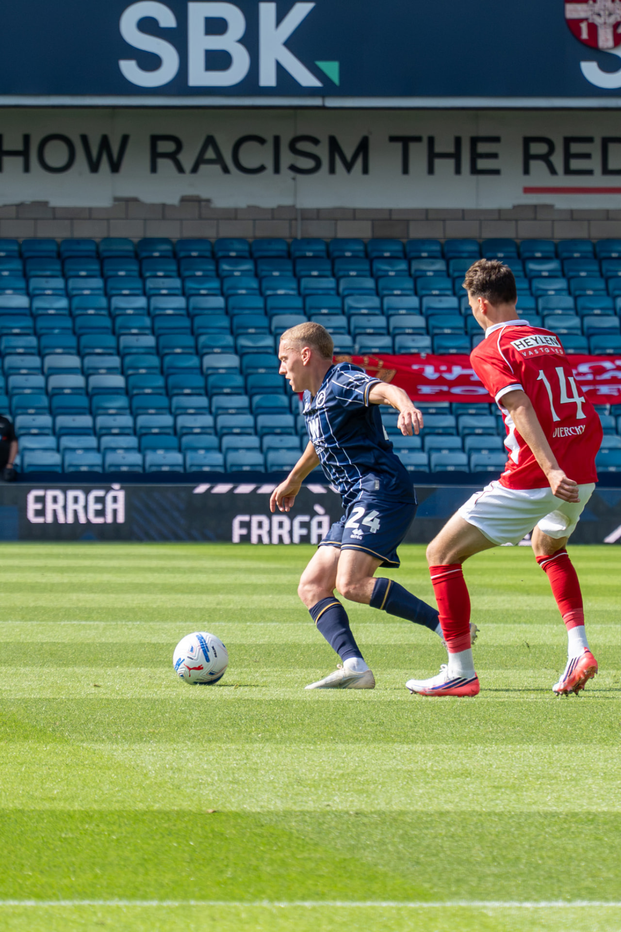 Millwall number 24 running at a defender