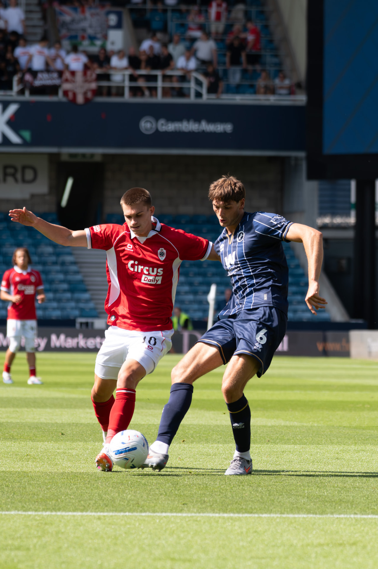 Two players stretching for the same ball