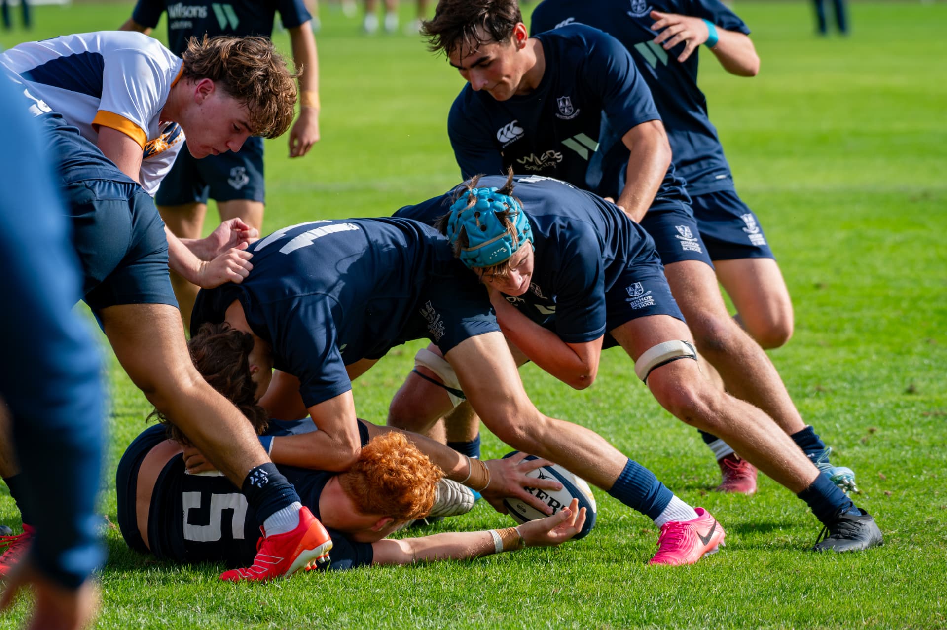 Rugby players competing for the ball at a breakdown