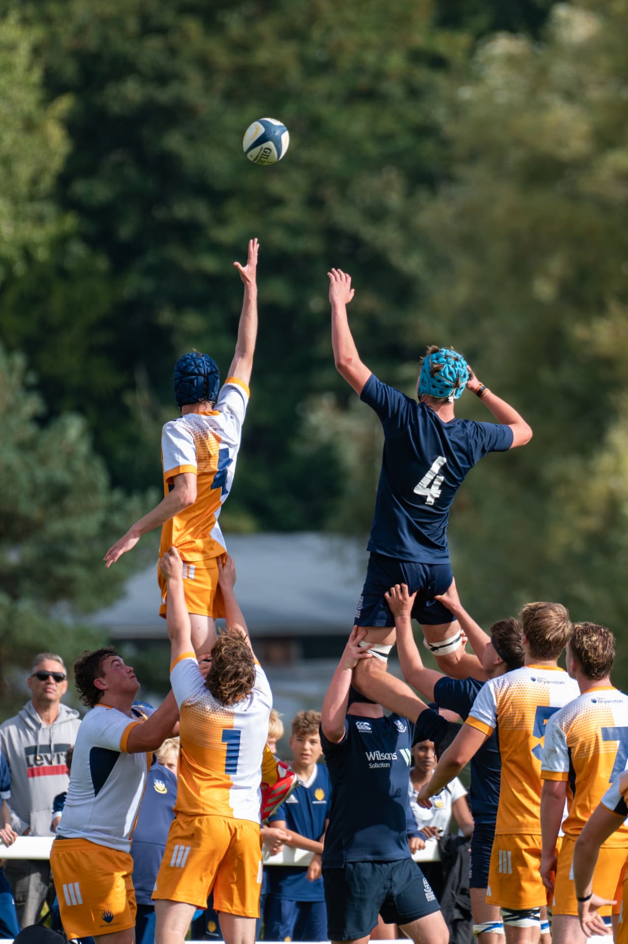 Two rugby players competing for the ball at a lineout