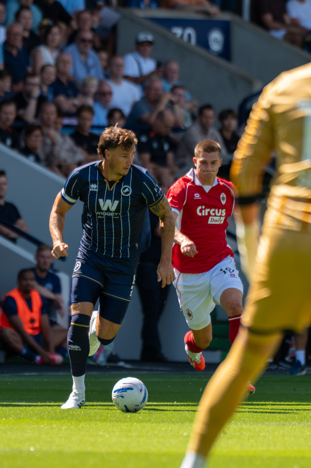 Millwall player driving forward with the ball