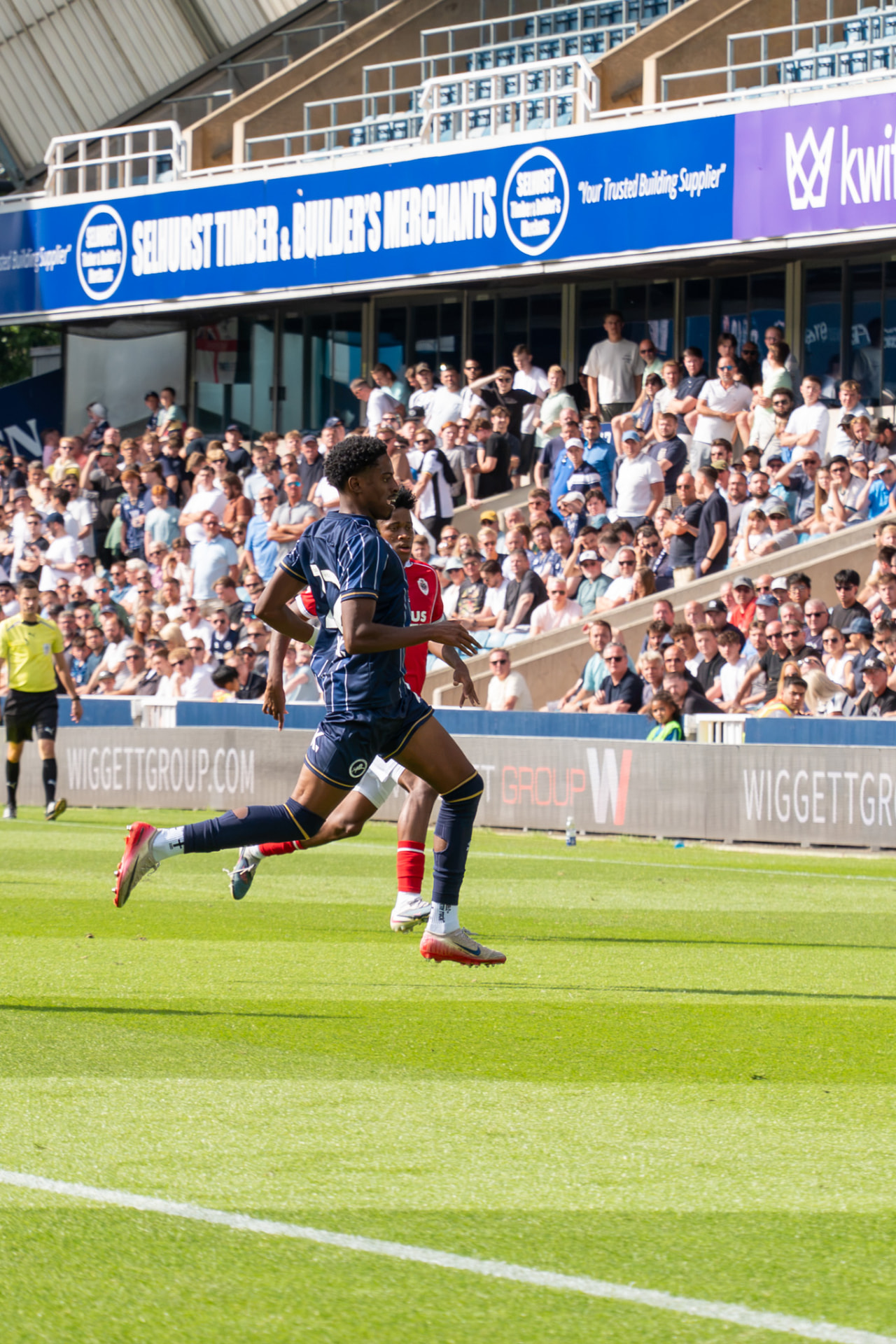 Millwall player sprinting away from an opponent
