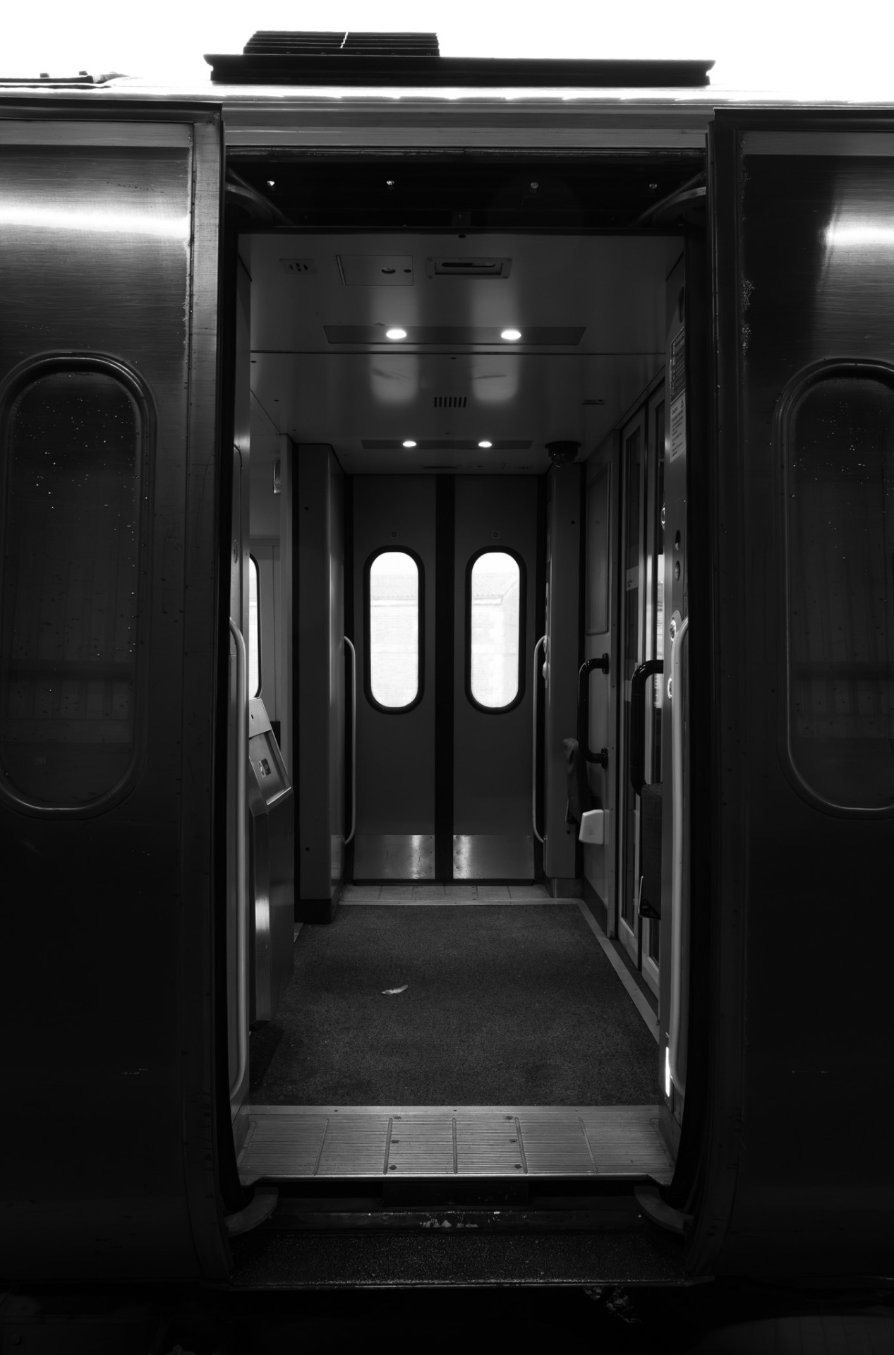 Looking through the open doors of an empty train vestibule