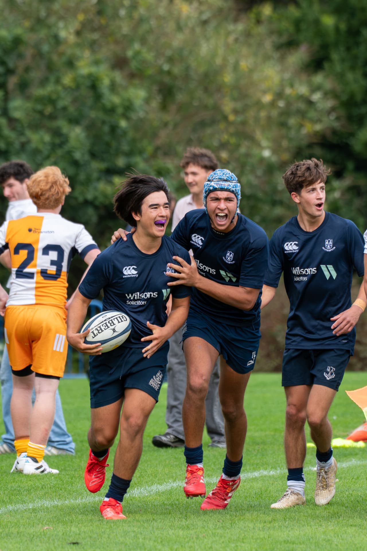 Rugby player running the ball in to score