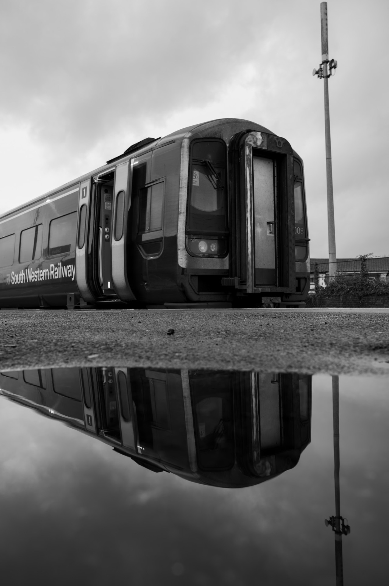 South Western Railway train reflected in a puddle
