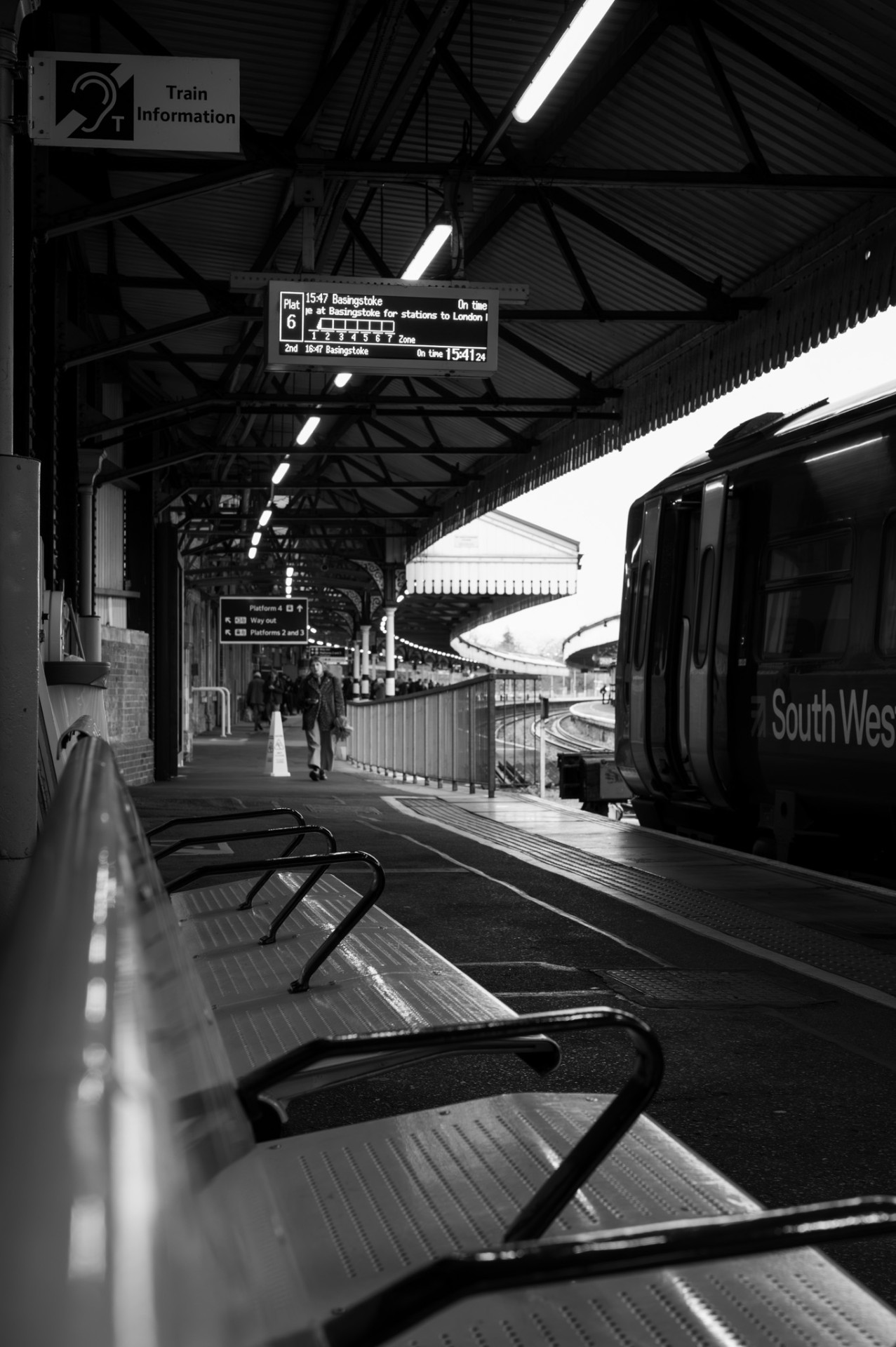 Platform benches with a South Western train arriving