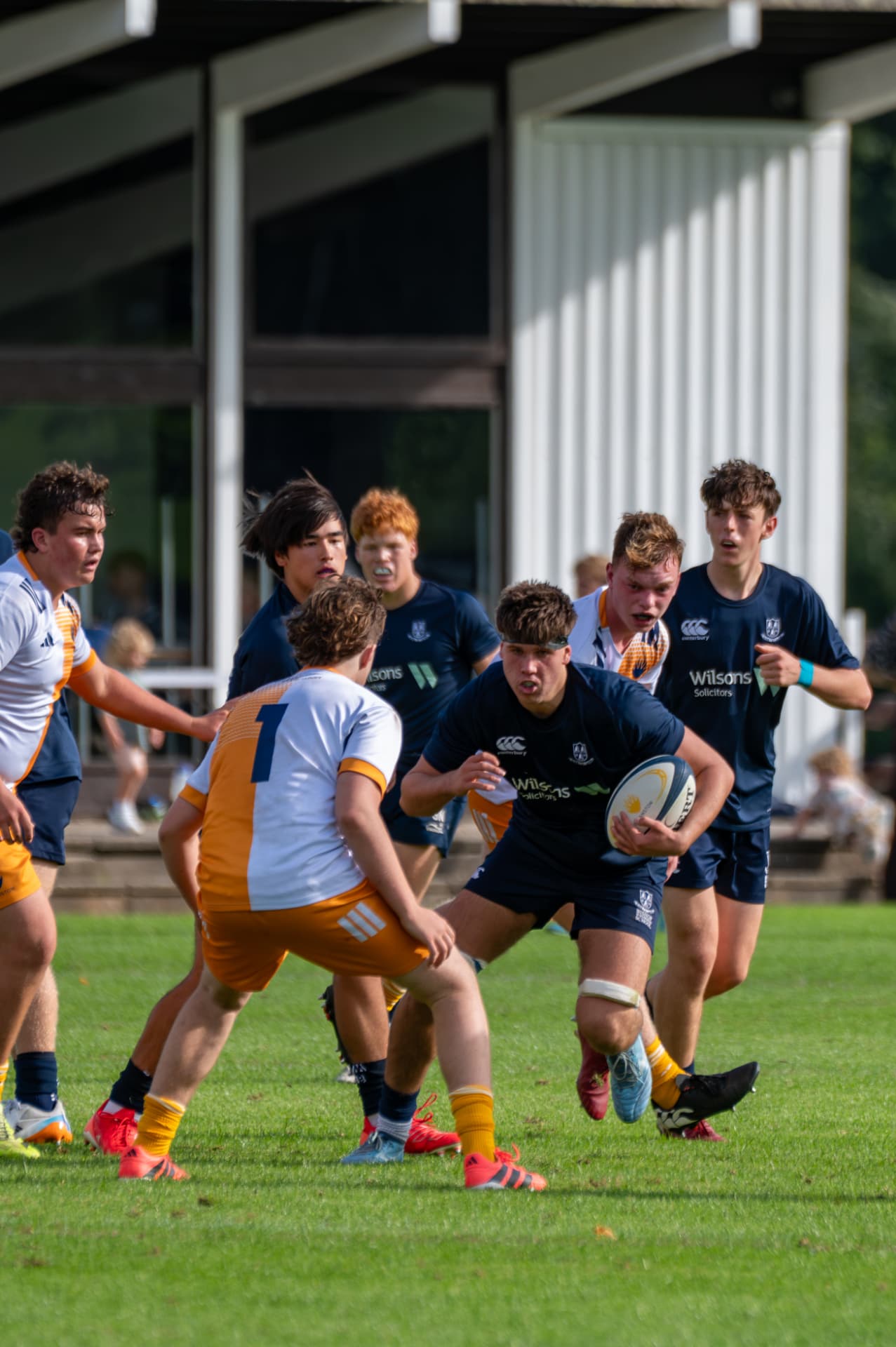 Rugby ball carrier driving towards the defensive line