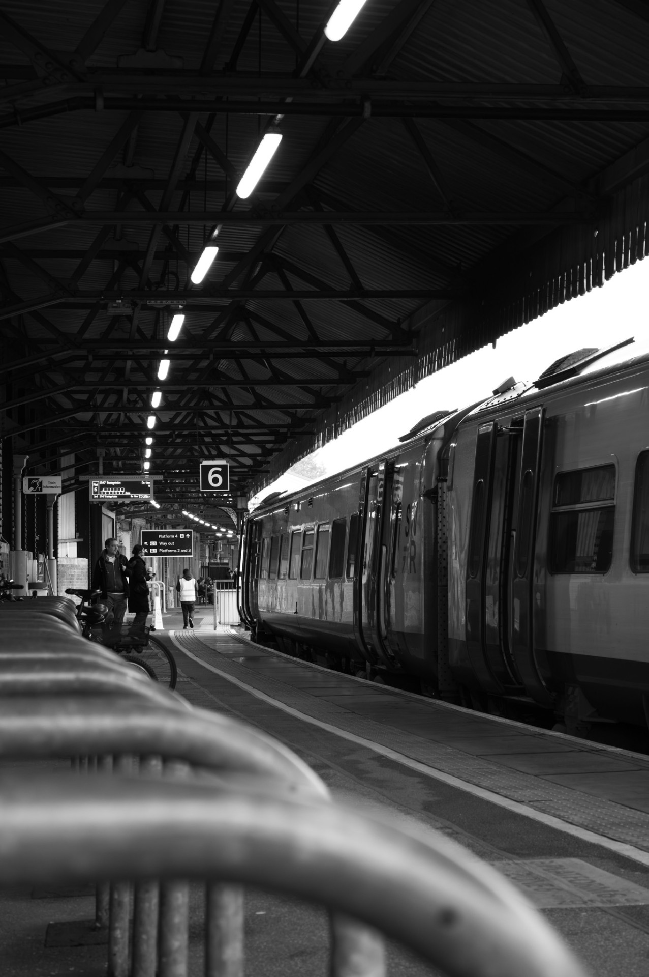 Long view down platform six beside a waiting train