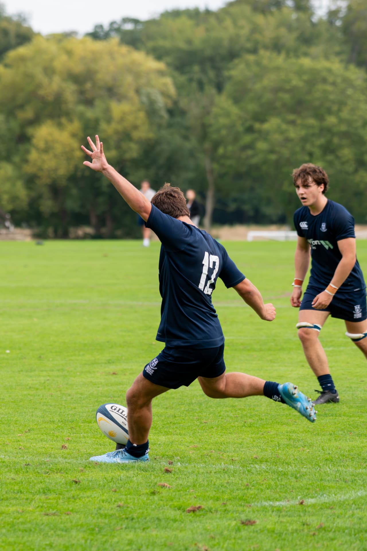 Rugby player kicking the ball from hand
