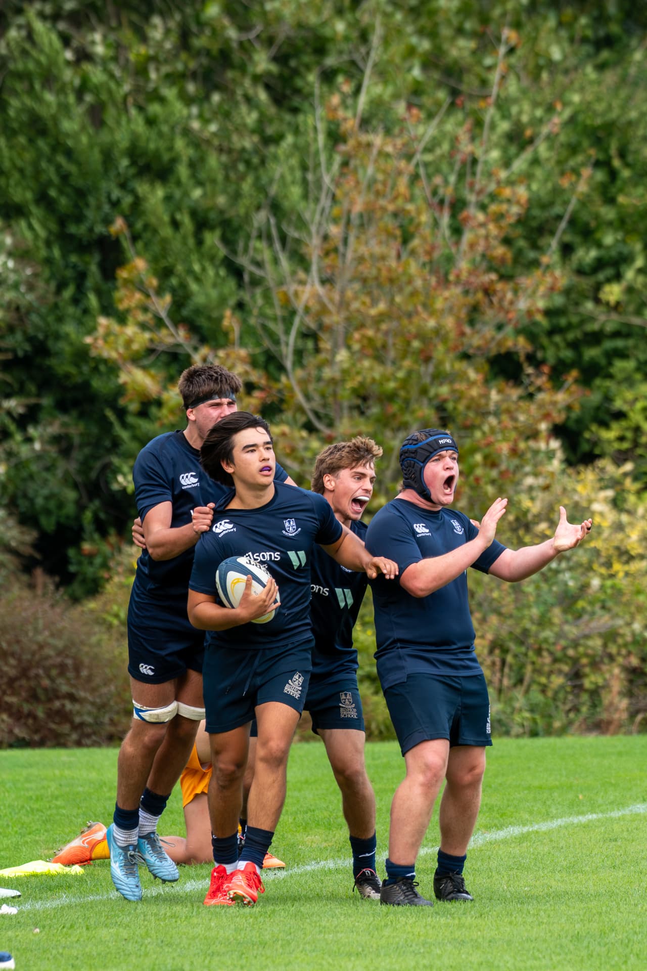 Rugby players celebrating together after a decisive play