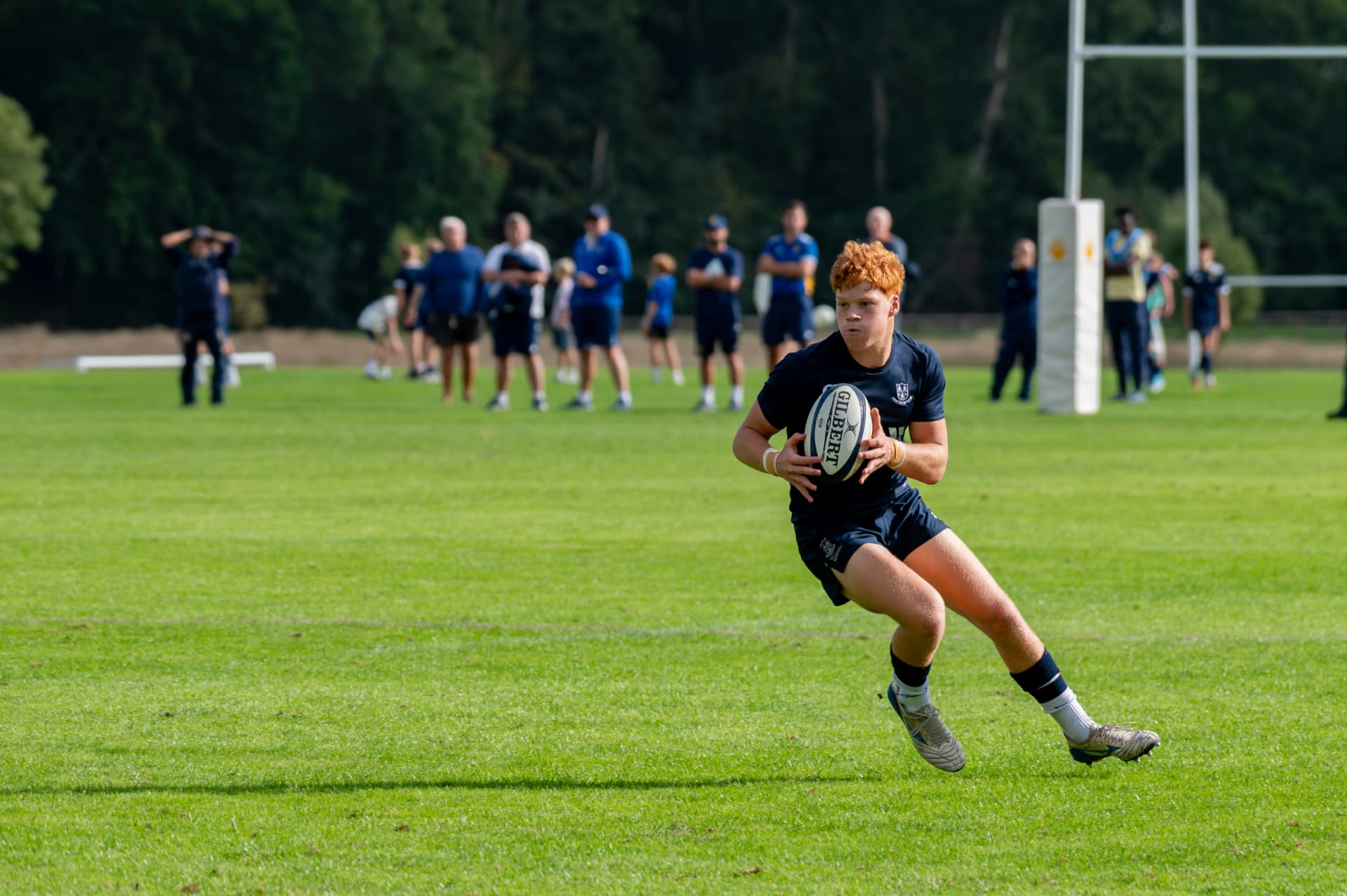 Rugby player carrying the ball into open space