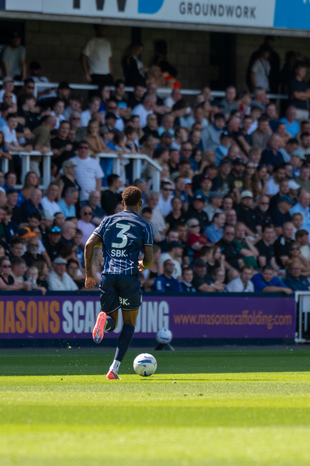 Full back running with the ball down the wing